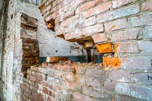 View of break wall in old factory. Old abandoned ruin factory damage building inside photo