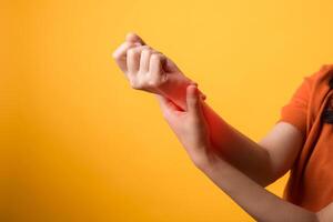 Woman wrist suffering from inflammation and pain, illustrating arthritis discomfort. Studio portrait of health issue. photo