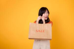 Embrace the shock of unbeatable deals while shopping. Happy young woman showcases her purchases, reflecting the thrill of discovering exciting bargains. photo