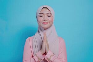 AI generated Beautiful Asian Muslim woman with a radiant smile, making an Eid Mubarak greeting gesture, isolated on a clean background, representing the concept of religious lifestyle photo