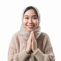 AI generated Beautiful Asian Muslim woman with a radiant smile, making an Eid Mubarak greeting gesture, isolated on a clean background, representing the concept of religious lifestyle photo