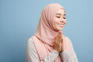 AI generated Beautiful Asian Muslim woman with a radiant smile, making an Eid Mubarak greeting gesture, isolated on a clean background, representing the concept of religious lifestyle photo