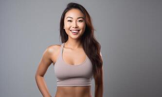 AI generated Beautiful Young Asian Woman Showcasing Strength and Determination in Dynamic Workout Poses, Fitness Session, Isolated Against a studio Background photo