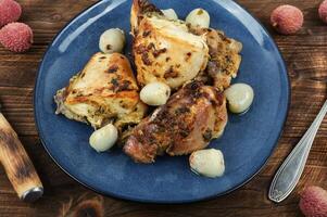 Grilled or smoked chicken with lychee. photo