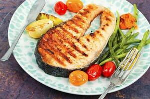 Plate of grilled salmon steak. photo