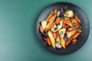 Roasted parsnip root and carrots. photo