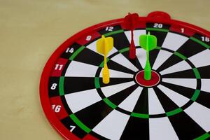 Magnetic dart in the center of target, scoring in throwing game for children, aiming to bullseye photo