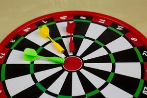 Colored magnetic darts lie on target, a children safe game of throwing weapons and scoring points photo