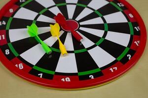 Dartboard made of magnetic material with safe darts for children, game of throwing projectile at target photo