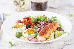 Breakfast homemade chicken sausage with boiled egg and fresh salad. Keto, ketogenic breakfast. Trendy breakfast. photo