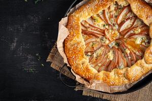 Galette with pear and blue cheese dipped in honey. Healthy eating. Top view photo