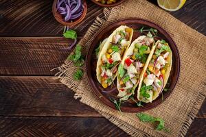 Mexican tacos with chicken meat, corn and salsa. Healthy tacos. Diet menu. Mexican taco. Top view, flat lay photo