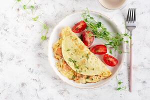 Healthy breakfast. Quesadilla with omelette, salmon  and sliced tomatoes. Keto, ketogenic lunch. Top view photo