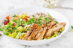 Lunch oatmeal porridge with grilled chicken fillet and fresh vegetables. Healthy balanced food. Trendy food. photo