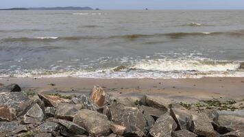 Waves crashing on the rocks at the beach photo