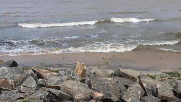 Waves crashing on the rocks at the beach photo