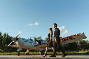 Two business colleagues standing by a plane photo