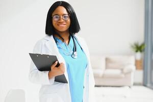 Successful black woman doctor smiling in office. photo