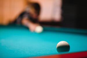 game of billiards the hand of a man with a billiard cue aims at a billiard ball photo