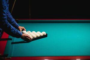 Playing billiard - Close-up shot of a man playing billiard photo