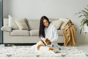 Portrait of happy woman with her dog at home. photo