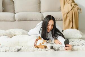 Portrait of happy woman with her dog at home. photo