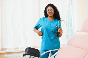 Professional female doctor on blurred consulting room background. African American gynecologist. Gynecology concept. photo