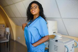 pretty female african doctor with arms crossed at hospital photo