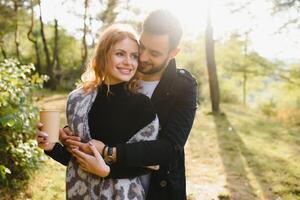 Romantic young couple in love relaxing outdoors in park. photo