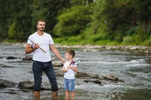 Father and son together fishing photo