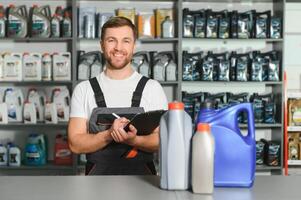 Portrait of a handsome salesman in an auto parts store. The concept of car repair photo