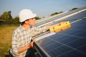 Worker installing solar panels outdoors photo