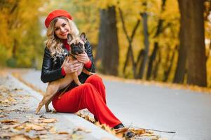 woman with dog walking in the park photo