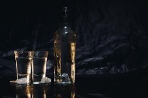 Vodka. Shots, glasses with vodka with ice .Dark background. Copy space .Selective focus. photo