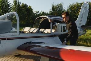 Young pilot is preparing for take off with private plane. photo