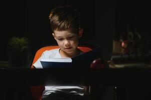 boy doing homework at home in evening photo