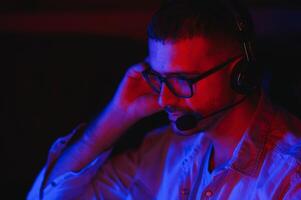 young man playing computer games on line photo