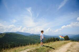 Young boy flies his kite in an open field. a pictorial analogy for aspirations and aiming high photo