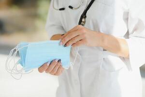 female doctor holding protective masks. photo