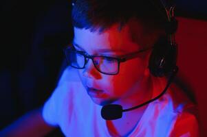 Boy in the headphones is playing a game. photo