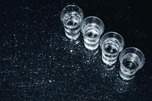 Vodka. Shots, glasses with vodka with ice .Dark background. Copy space .Selective focus. photo