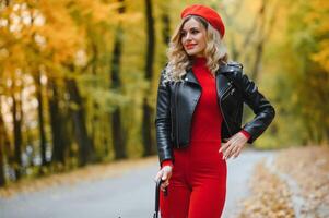 Beautiful girl with umbrella at autumn park. photo