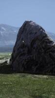 isolated stone on meadow in mountains video