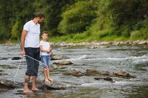 Father and son together fishing photo