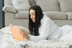 Smiling teen girl lying on floor and relaxing. photo