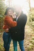 gentle and stylish couple are having a walk in the autumn park. photo