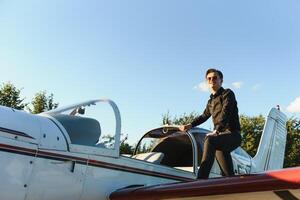 Young pilot is preparing for take off with private plane. photo