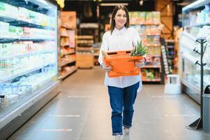 Woman shopping at the supermarket photo