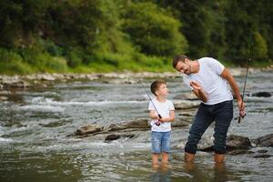 Father and son together fishing photo