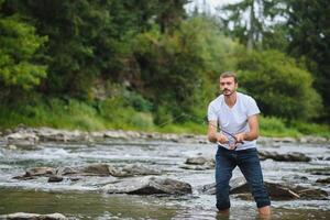 Man fly fishing casts on Irish river photo